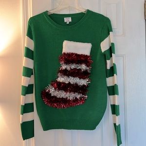 Green and white sweater with tinsel stocking